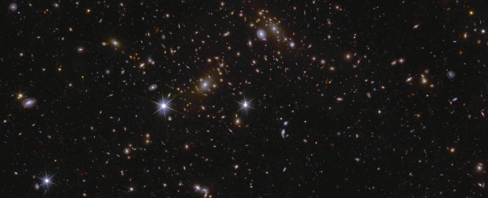 Image of an area of the Euclid Deep Field South showing several huge galactic clusters, as well as intracluster light and gravitational lensing.