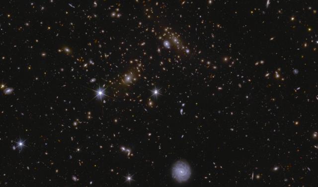Image of an area of the Euclid Deep Field South showing several huge galactic clusters, as well as intracluster light and gravitational lensing.