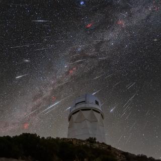 DESI observes the sky from the Mayall Telescope, shown here during the 2023 Geminid meteor shower.  Credit: KPNO/NOIRLab/NSF/AURA/R. Sparks