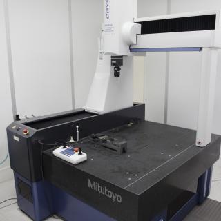 View of a three-coordinate measuring machine in the laboratory. Granite table with a gantry machine with a meter sensor